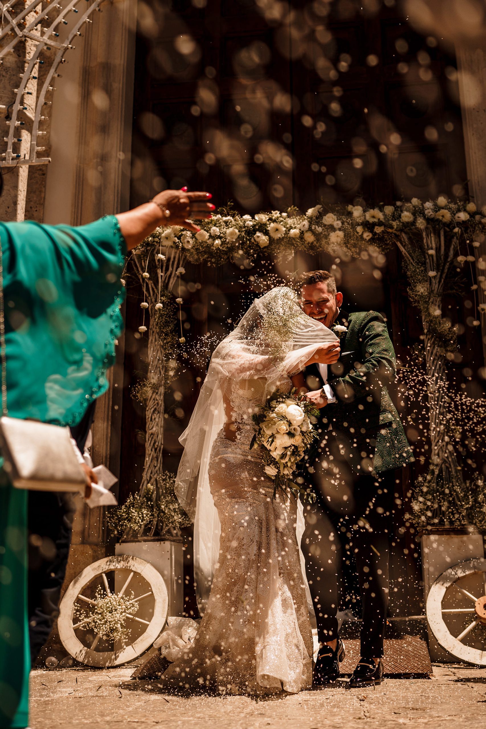 Confetti moment outside a church during a Sicily wedding
