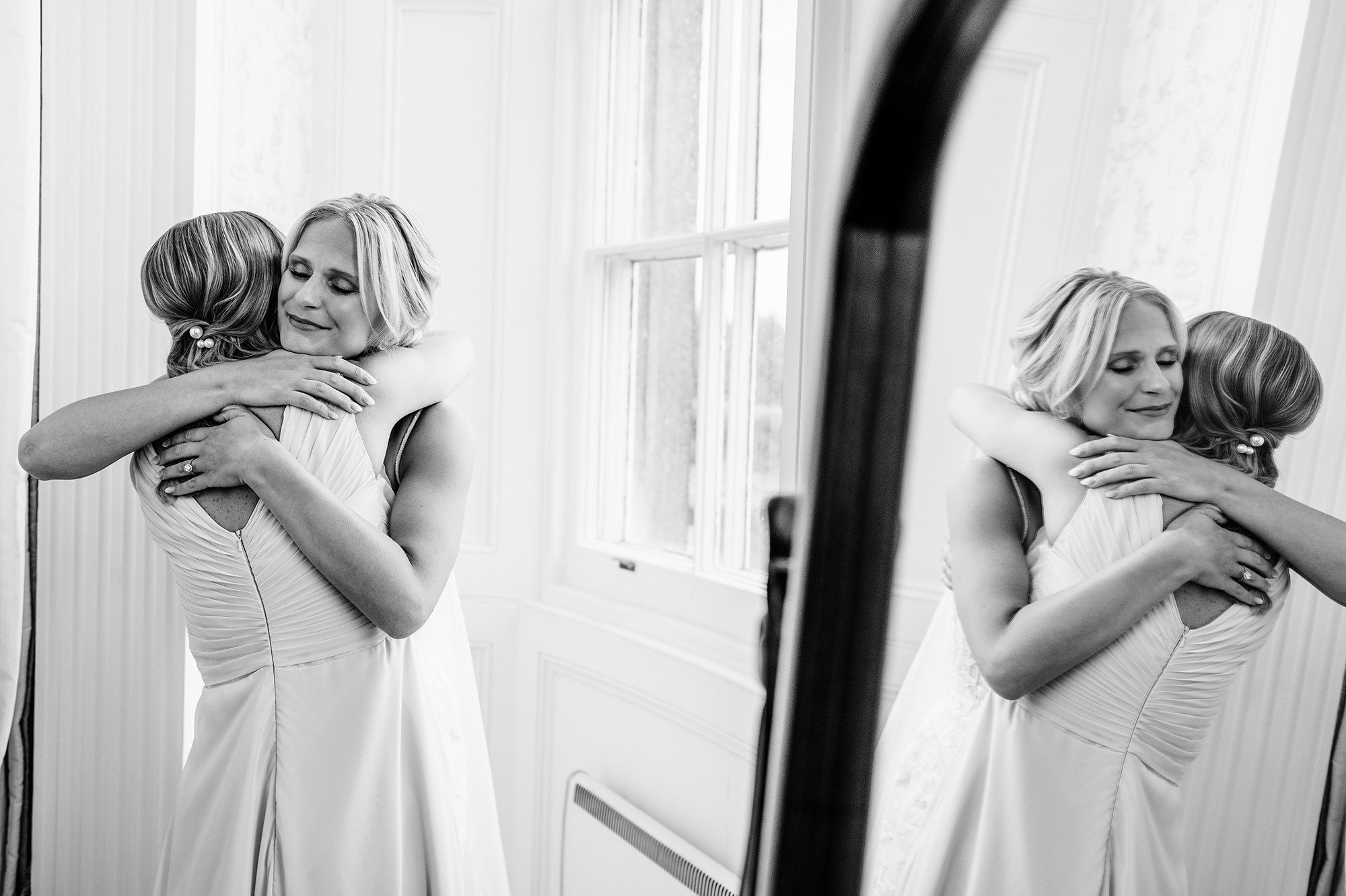 Bride hugging her sister during a candid wedding moment