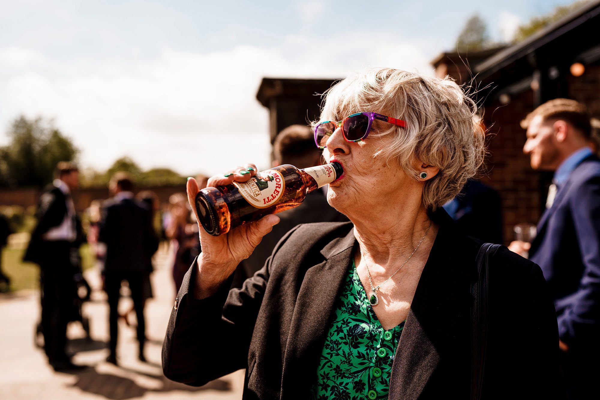 Wedding guest enjoying a drink during the celebrations