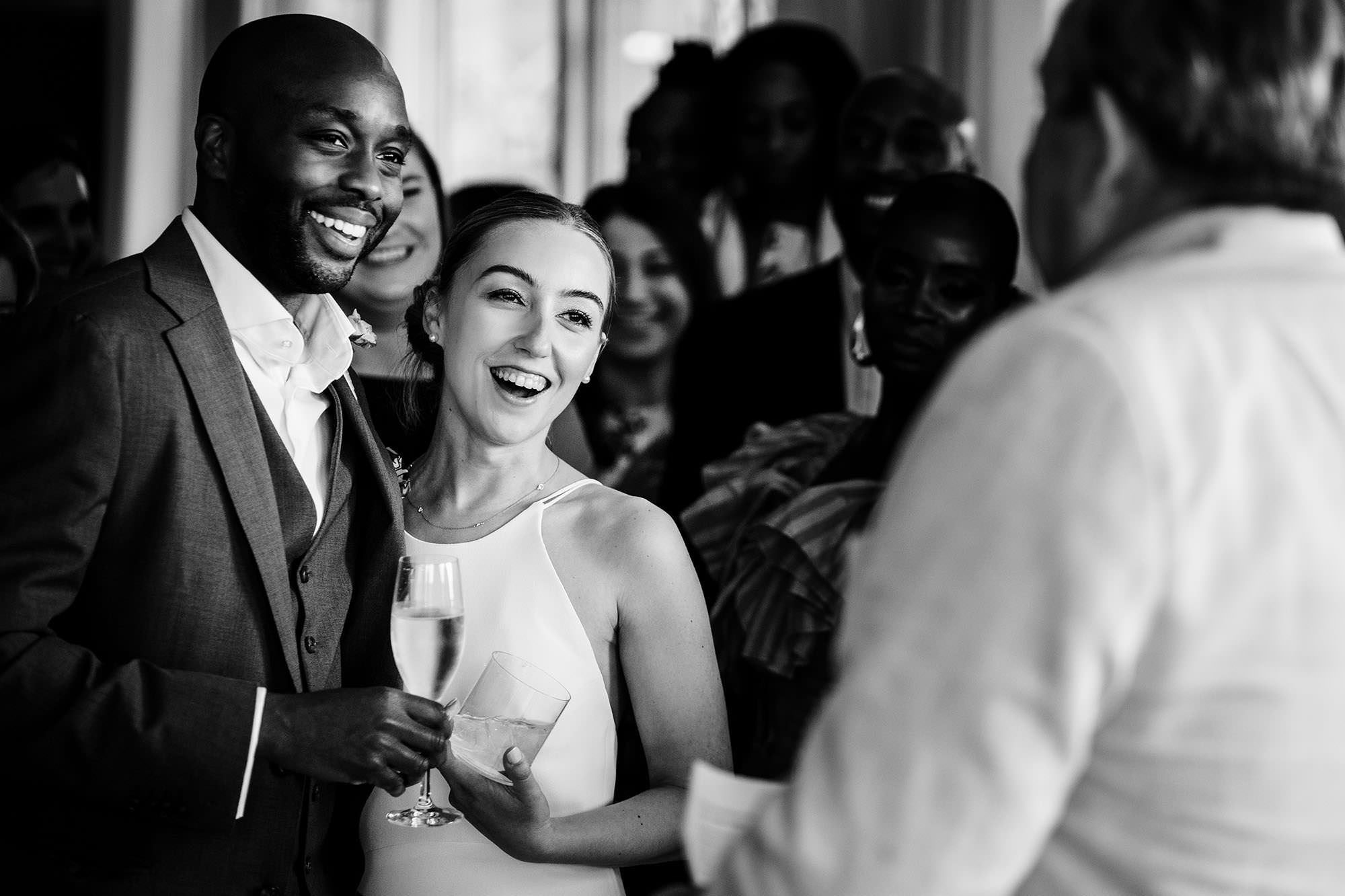Bride and groom reacting to a wedding speech in a natural moment