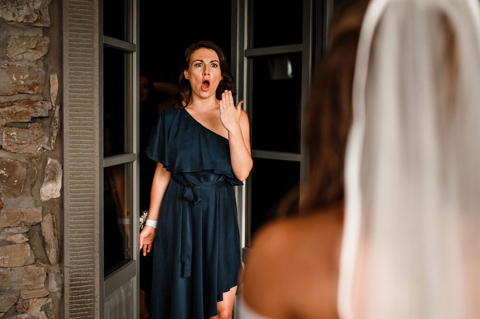 Bridesmaid looking at the bride during an emotional wedding moment