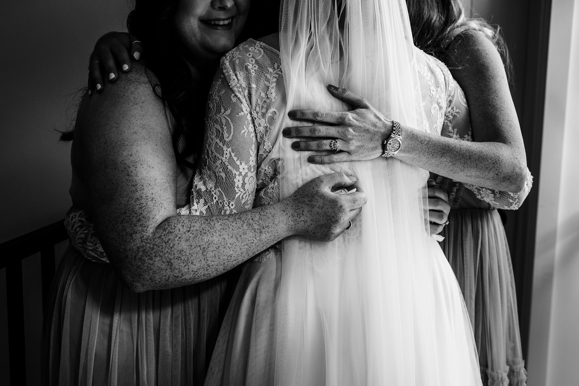 Emotional bridal hug during morning preparations at Calcot Hotel in the Cotswolds
