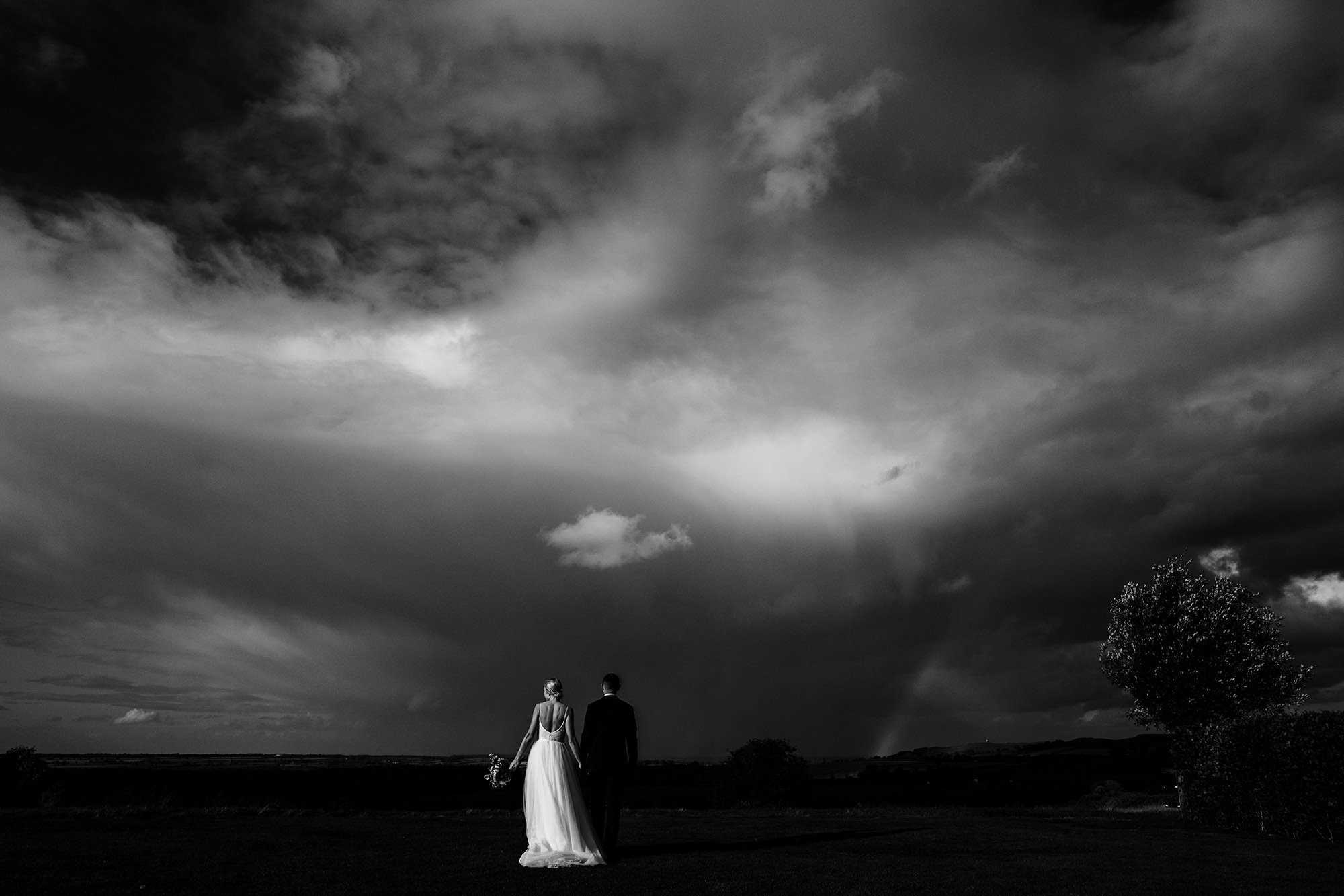 Moody bride and groom portrait in the Cotswolds countryside