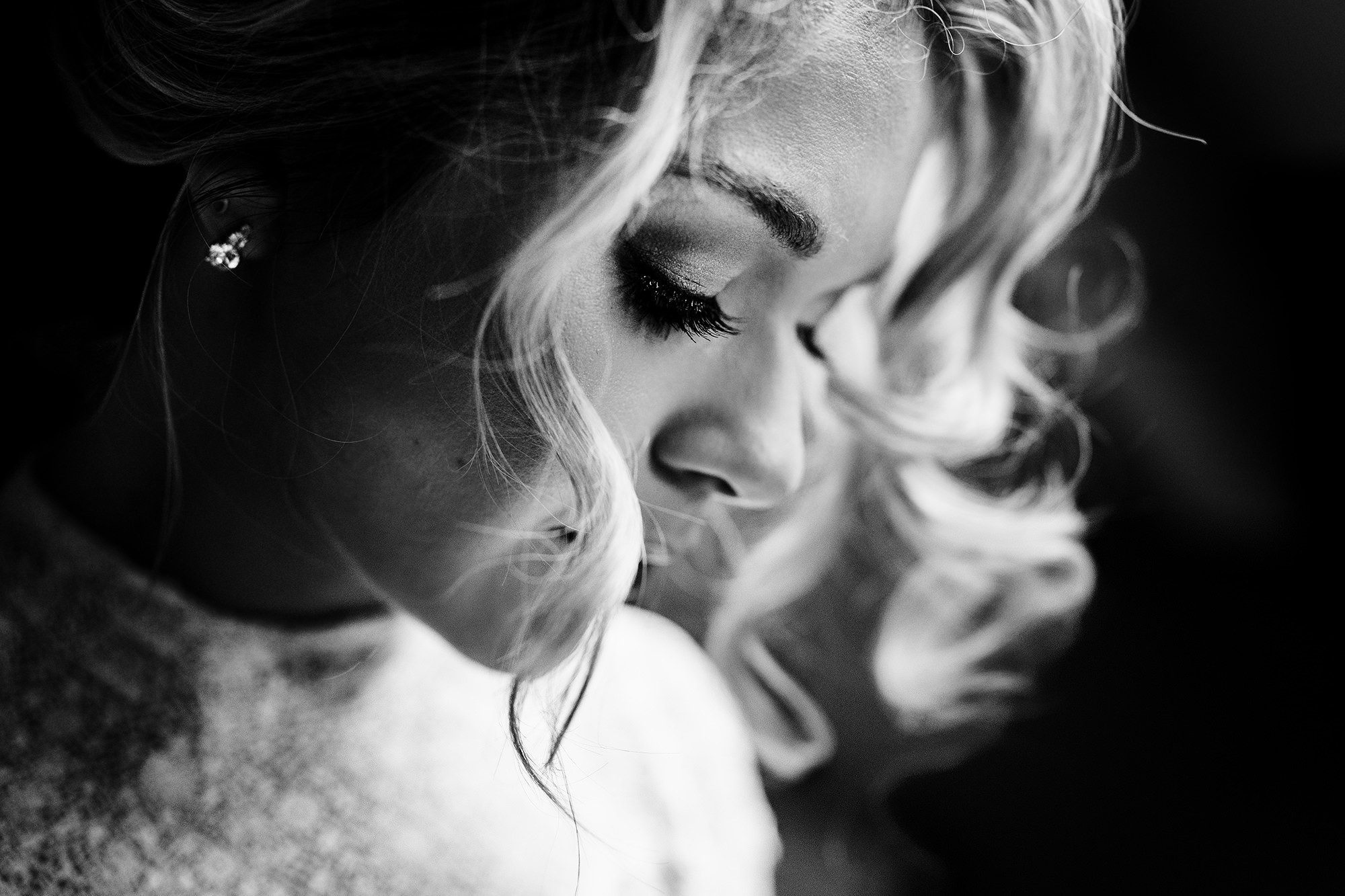 Close up of a bride having her makeup applied on the morning of her Cotswolds wedding