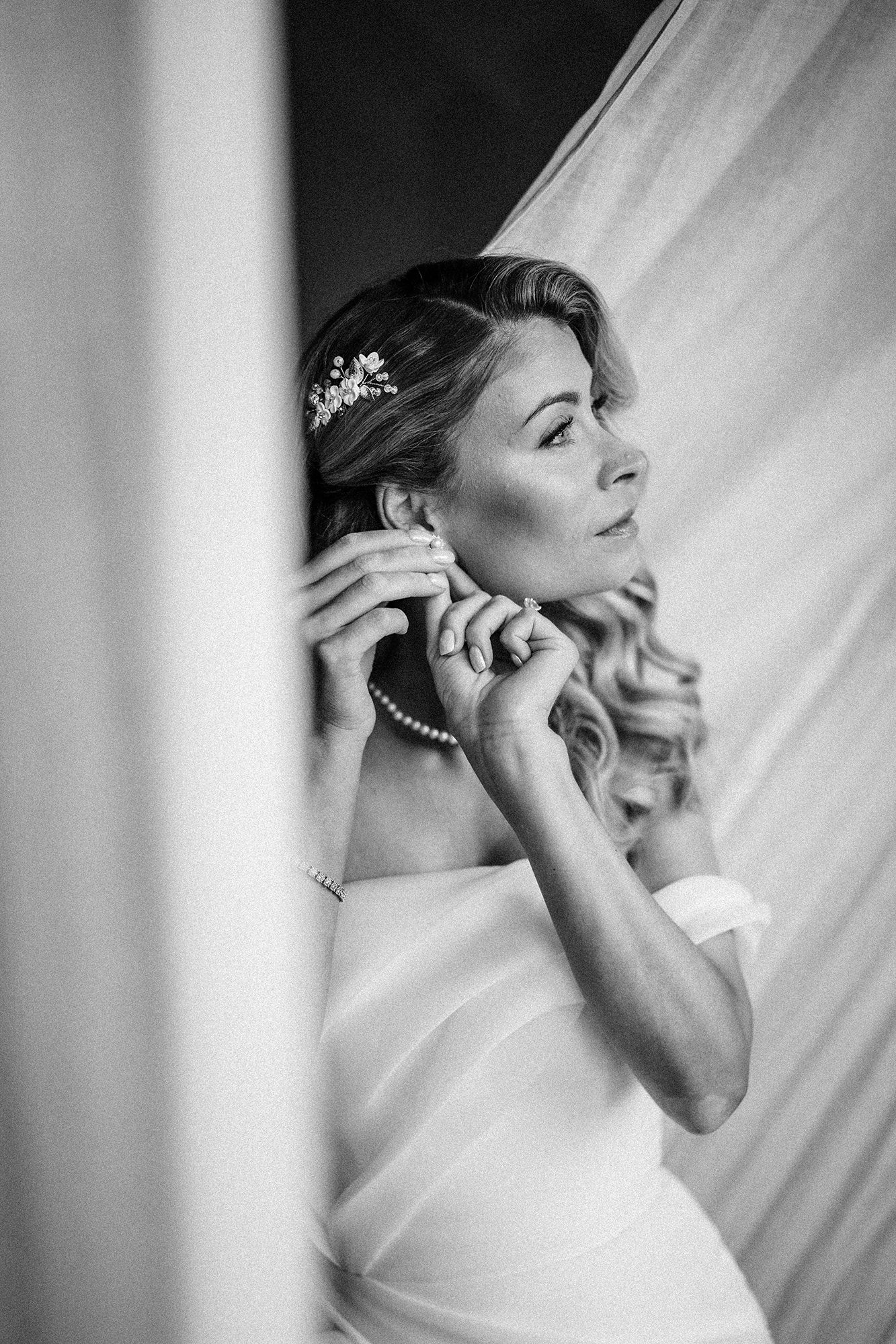 Bride getting ready in soft light on a wedding morning