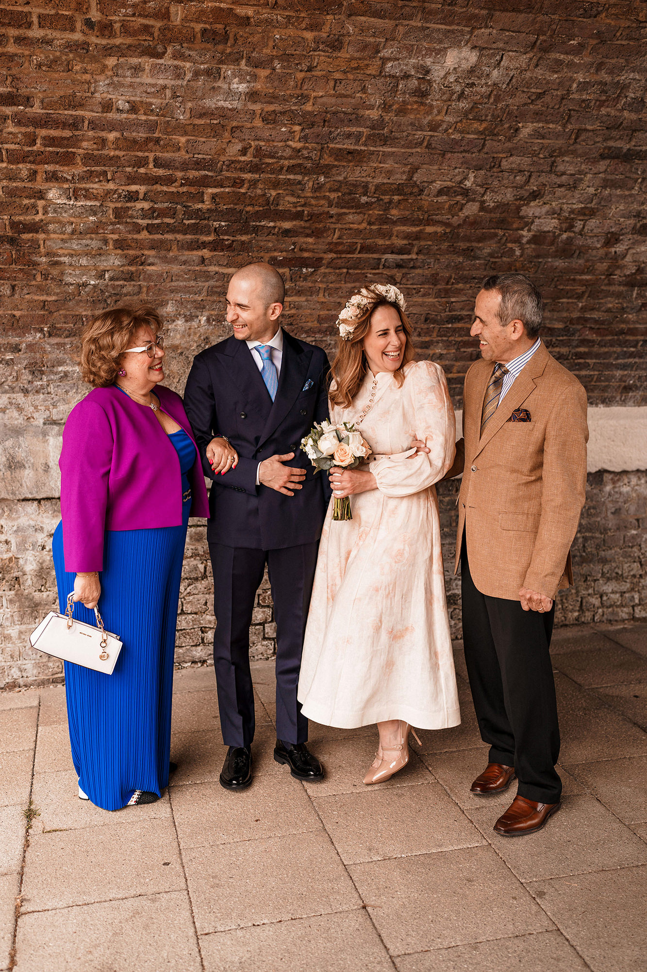 Bride and groom with parents during their intimate London wedding